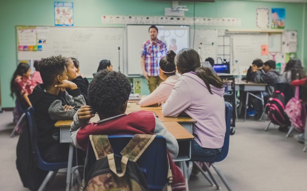 Teacher helping students in a classroom